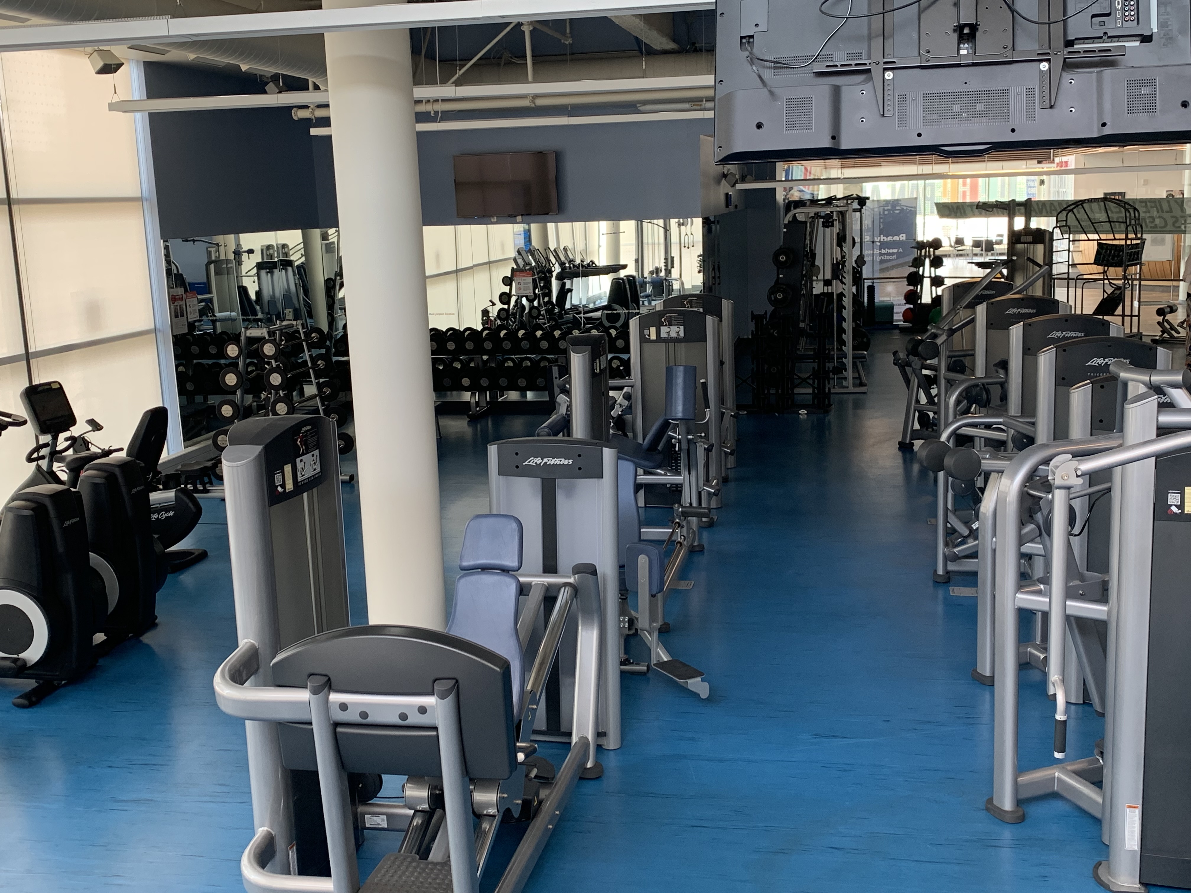 Variety of weighted resistance machines at a gym.