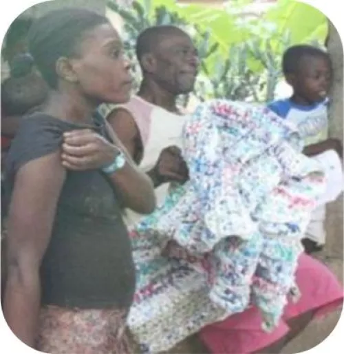 Residents in Haiti receiving sleeping mats