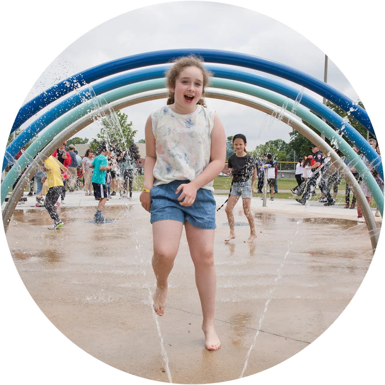Child playing in a City operated splashpad.