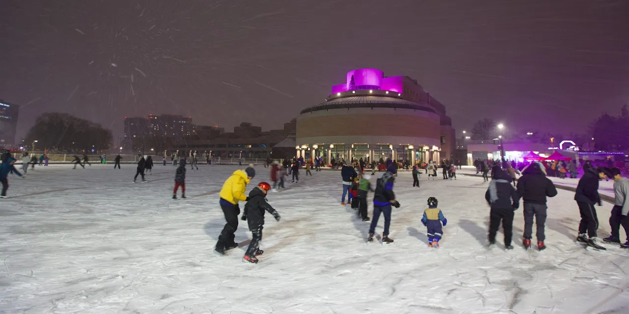 People skating on outdoor skate rink at Markham Civic Centre.