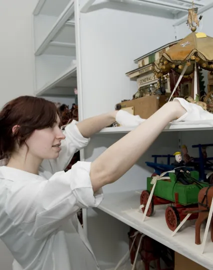 Staff handling display pieces.