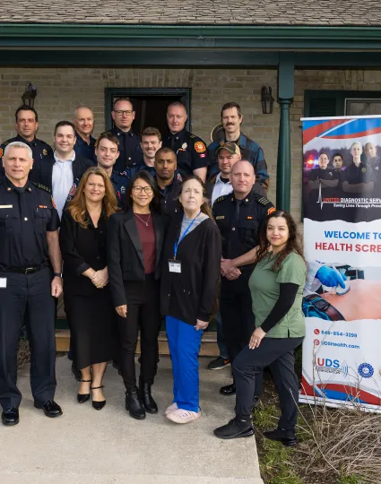 City staff and Markham Firefighters pose in front of the new On-Site Health Screening Program banner