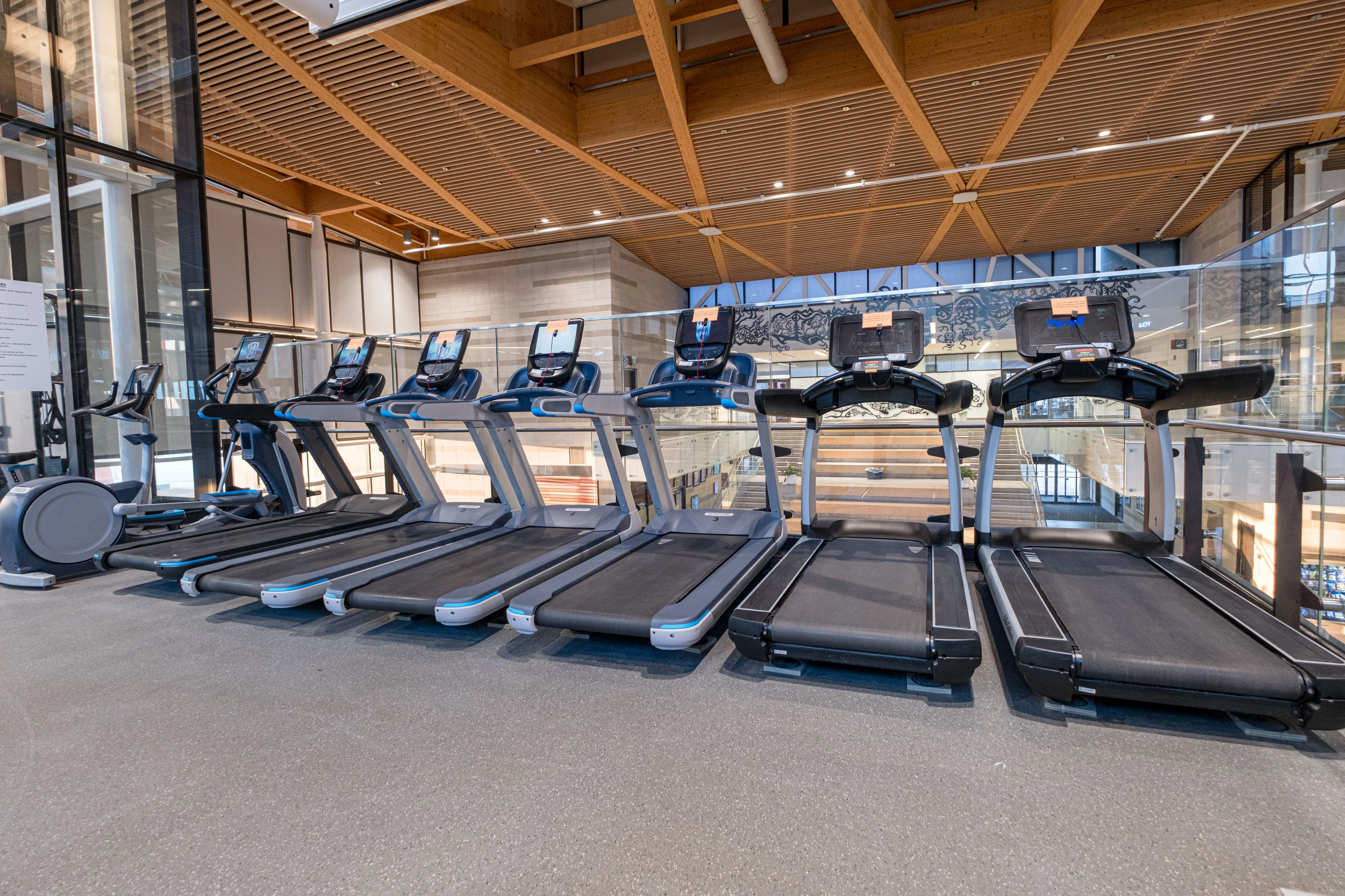 Treadmills lined up inside a community centre.