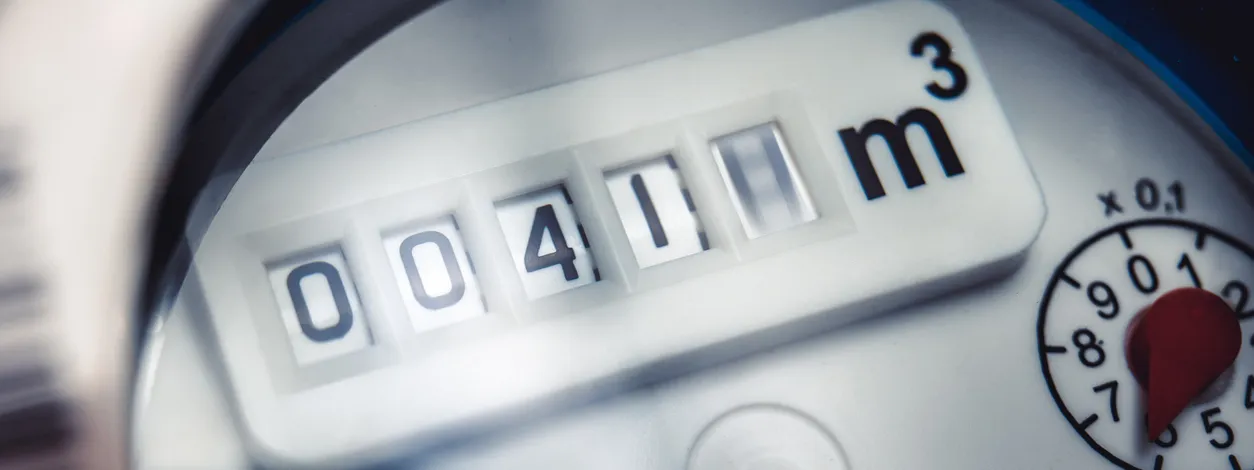 Close up of water meter with rotating digit.